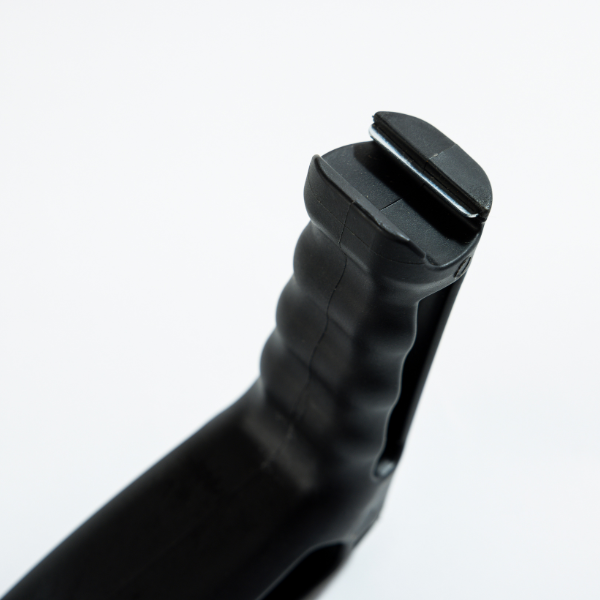 The textured, black grip of the Scrub Daddy BBQ Daddy tool, designed for comfortable and secure handling during grill cleaning.